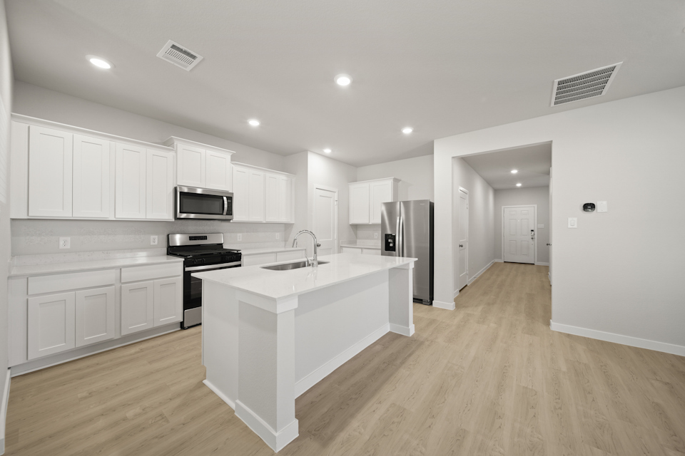 A kitchen with white cabinets.
