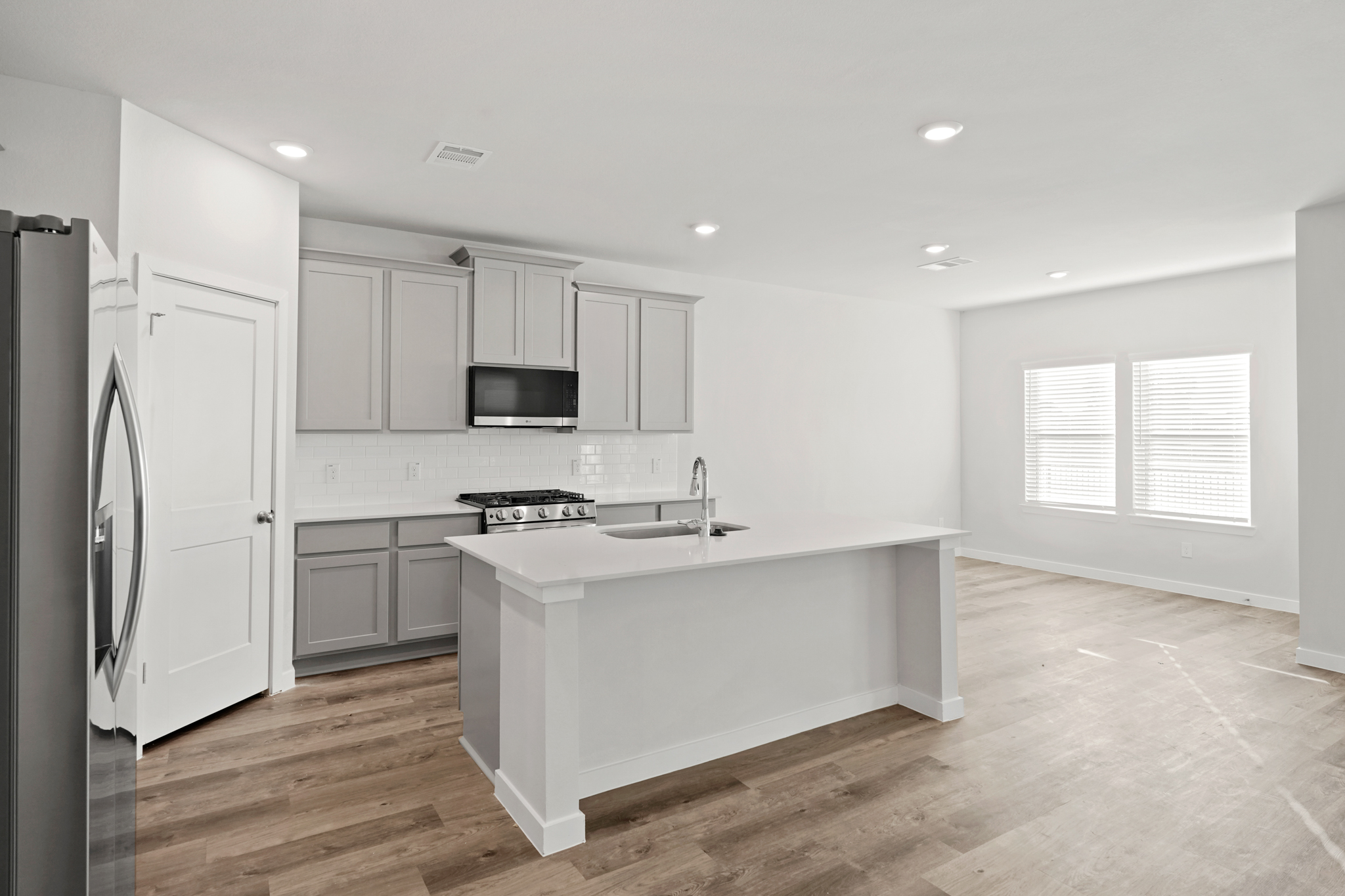 A kitchen with white cabinets.