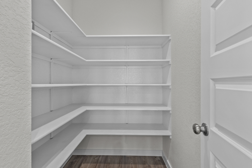 A white staircase with white walls.