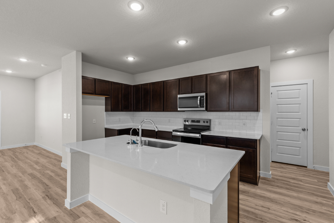 A kitchen with wooden cabinets.