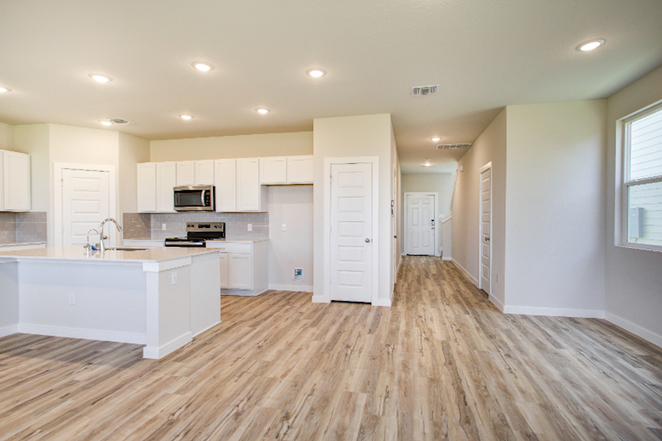 A large kitchen with white cabinets.