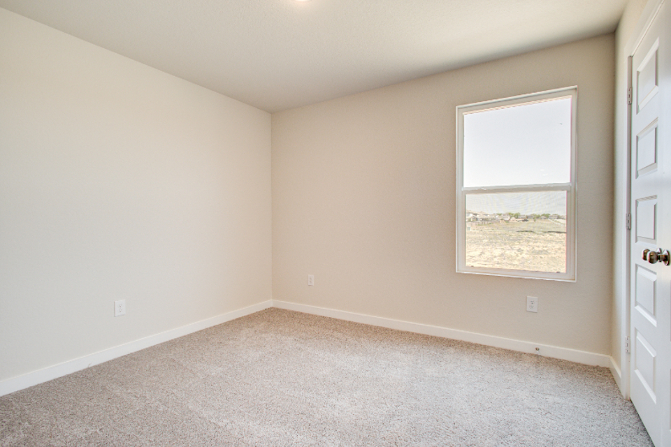 A room with a window and carpet.