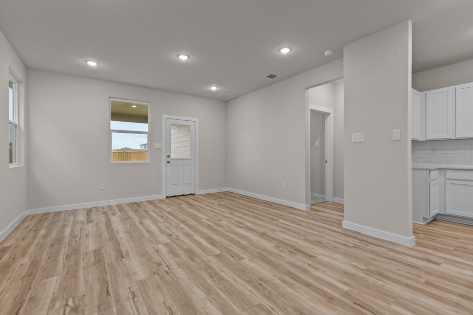 A room with white walls and wood floors.