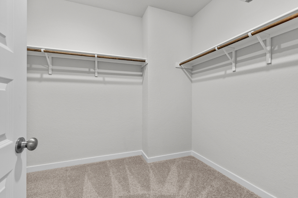 A white room with a metal railing.