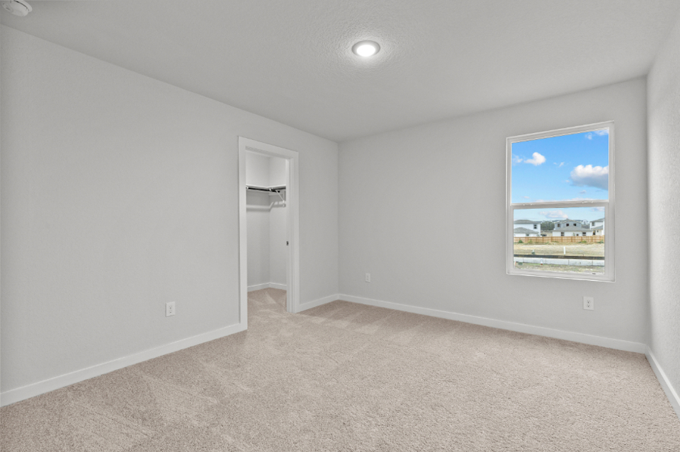 A room with a painting on the wall.