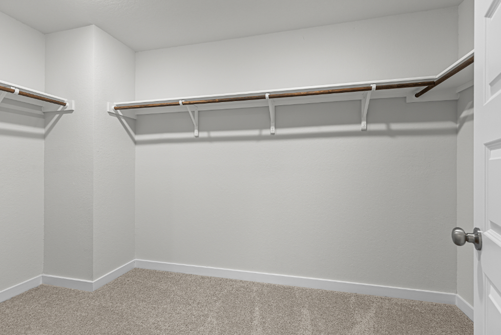 A white wall with a metal bar.