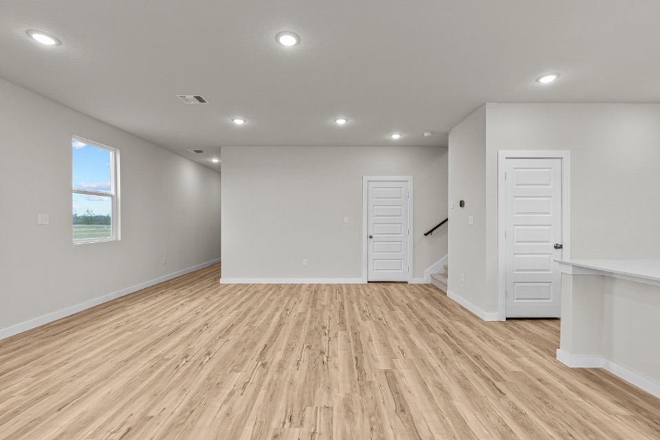 A room with white walls and a wood floor.
