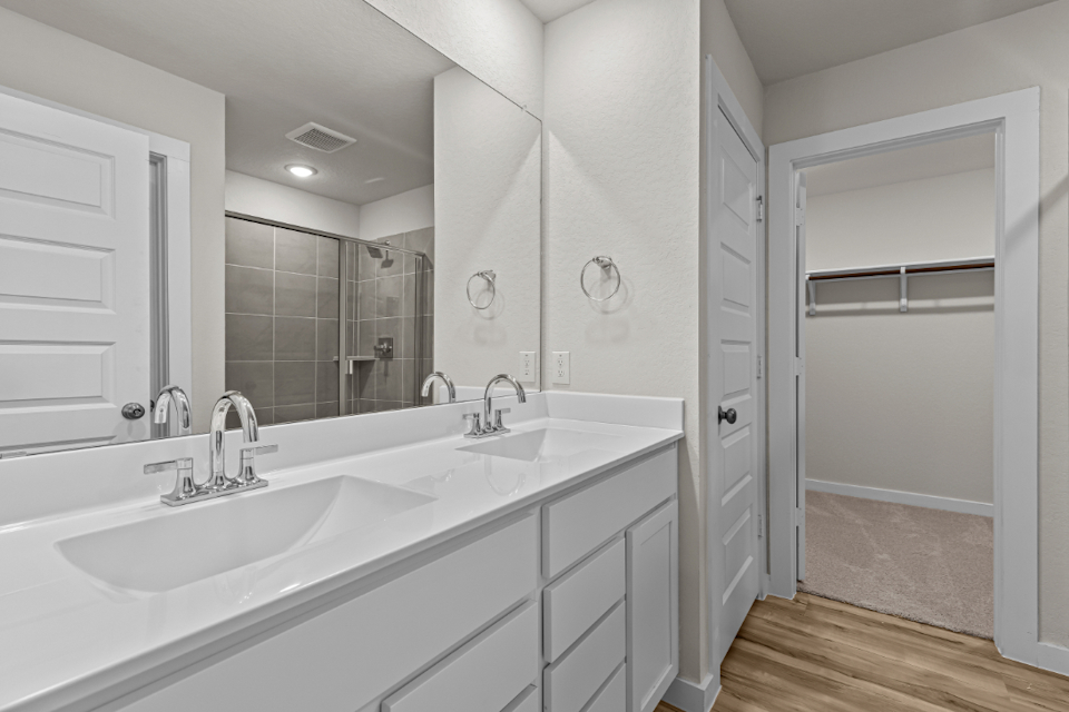 A bathroom with a large mirror.