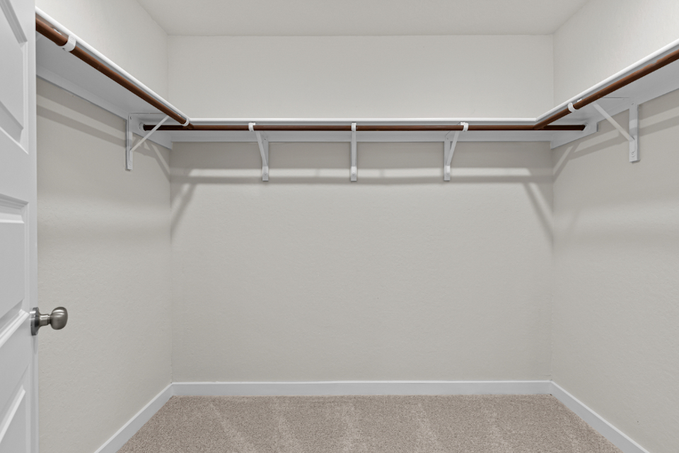 A white wall with a metal railing.