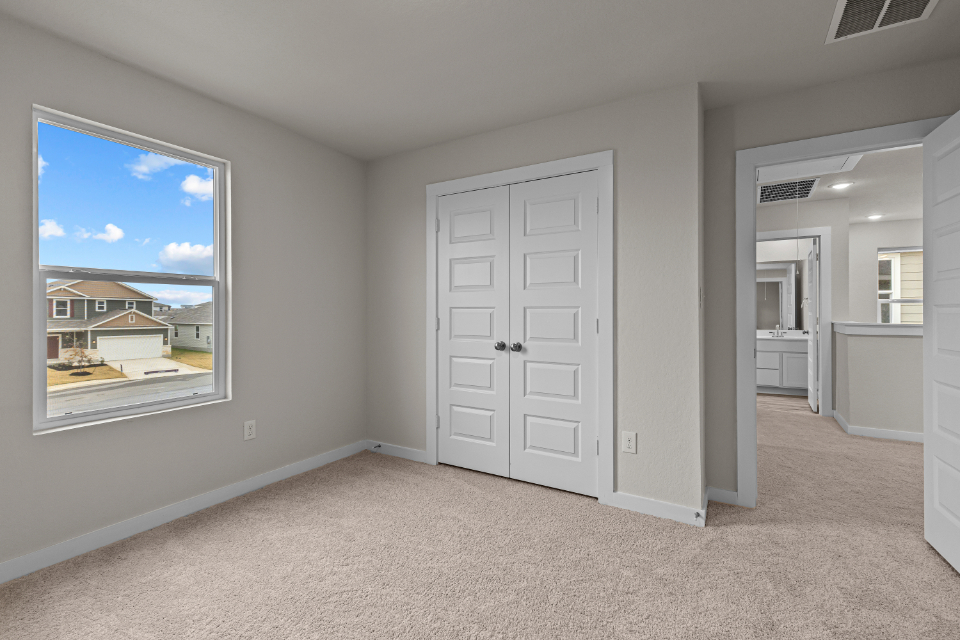 A room with white doors and a window.