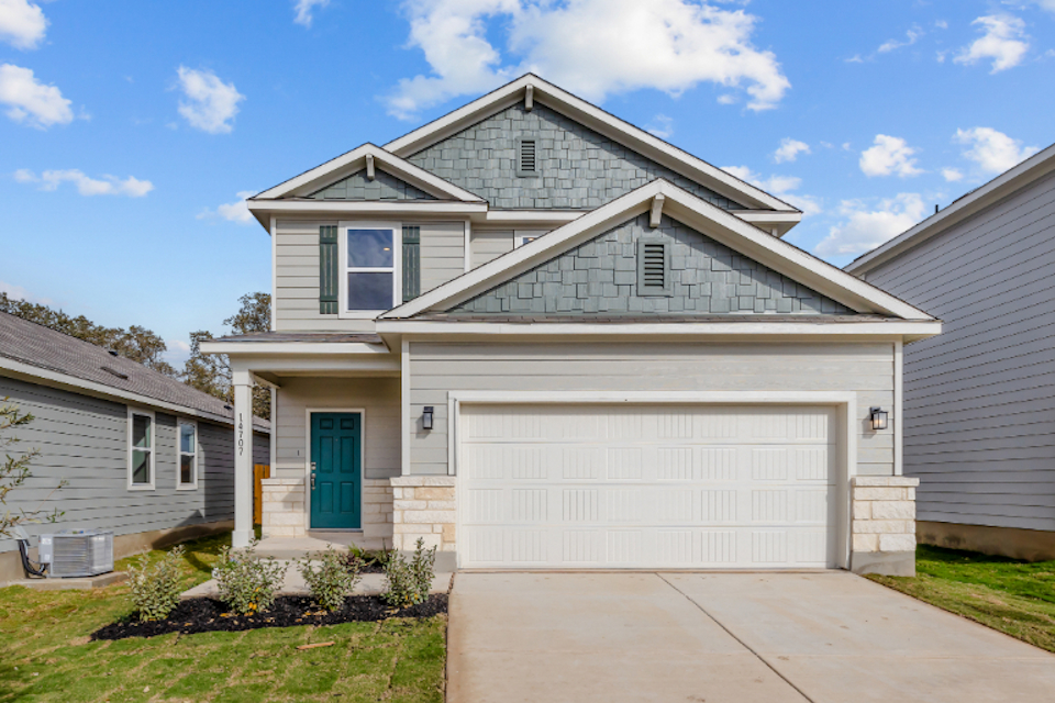A house with a garage with American Gothic House in the background.