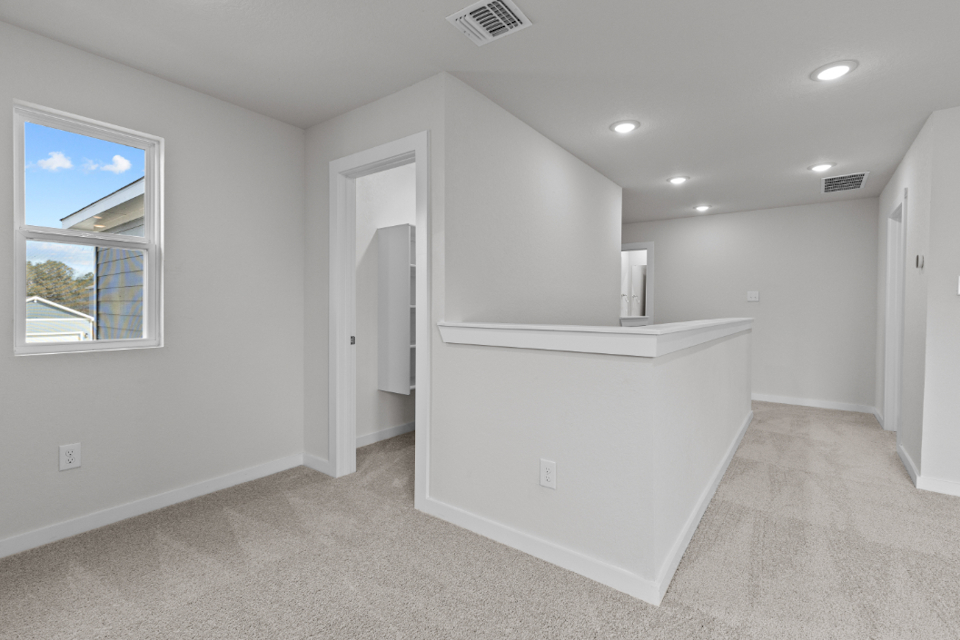 A room with a white cabinet and a window.