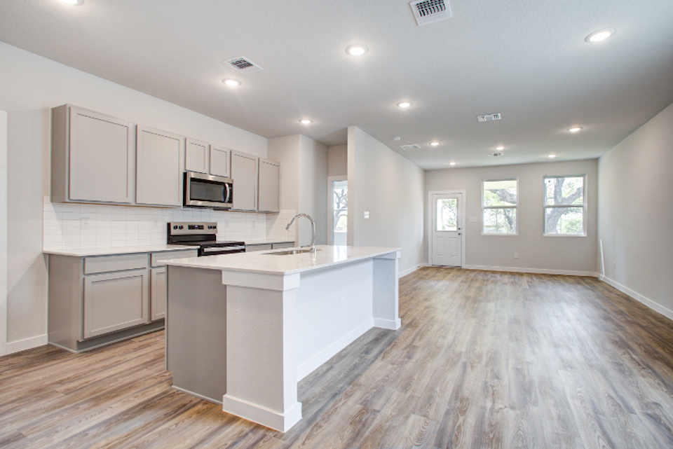 A kitchen with white cabinets.