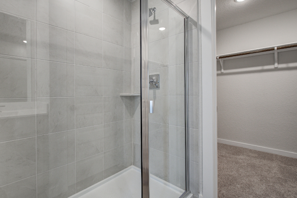 A shower with a glass door.