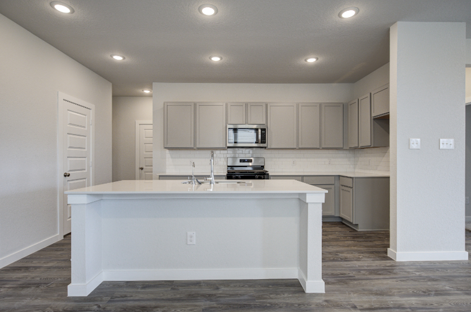 A kitchen with white cabinets.