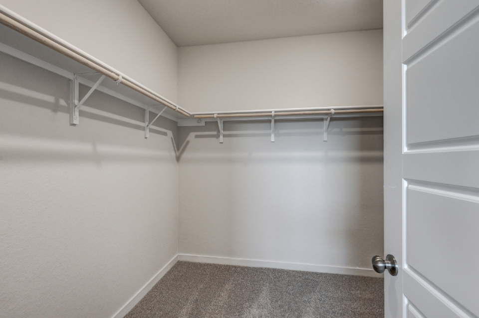 A white room with a metal railing.