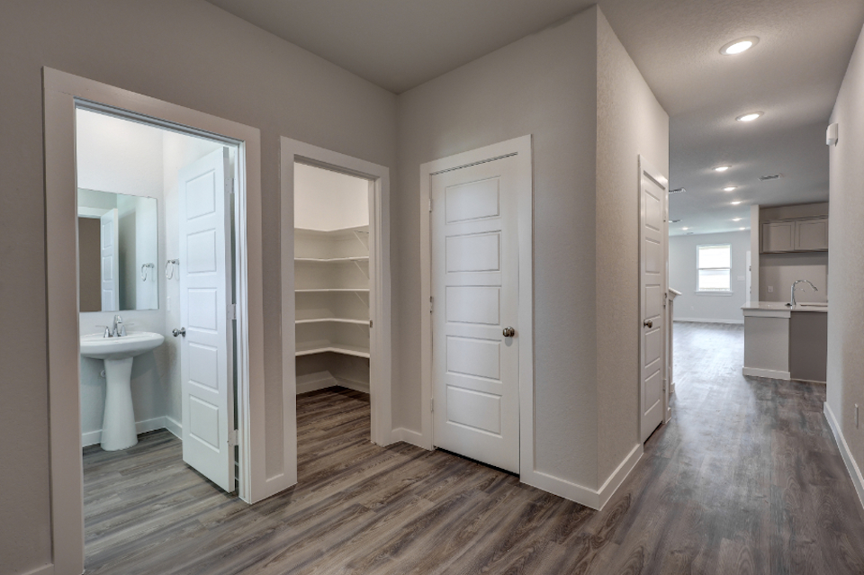 A bathroom with white cabinets.
