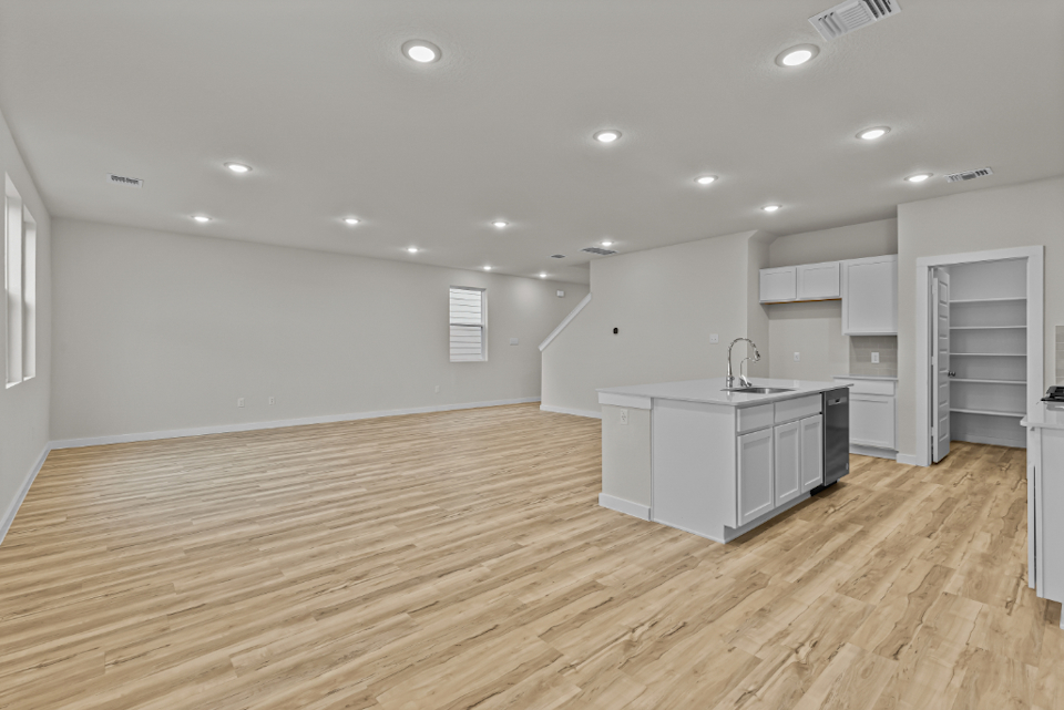 A kitchen with white cabinets.