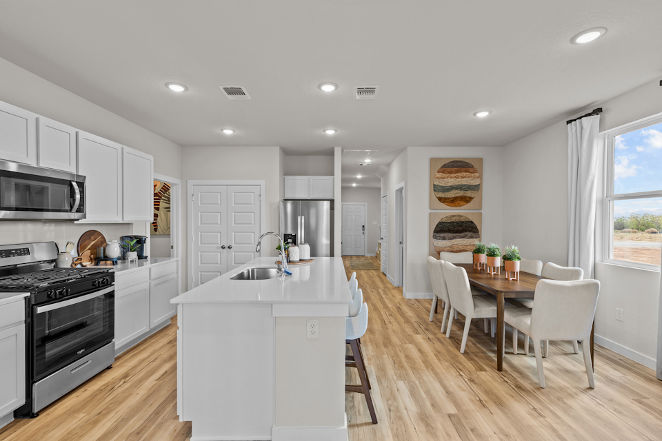 A kitchen with white cabinets.