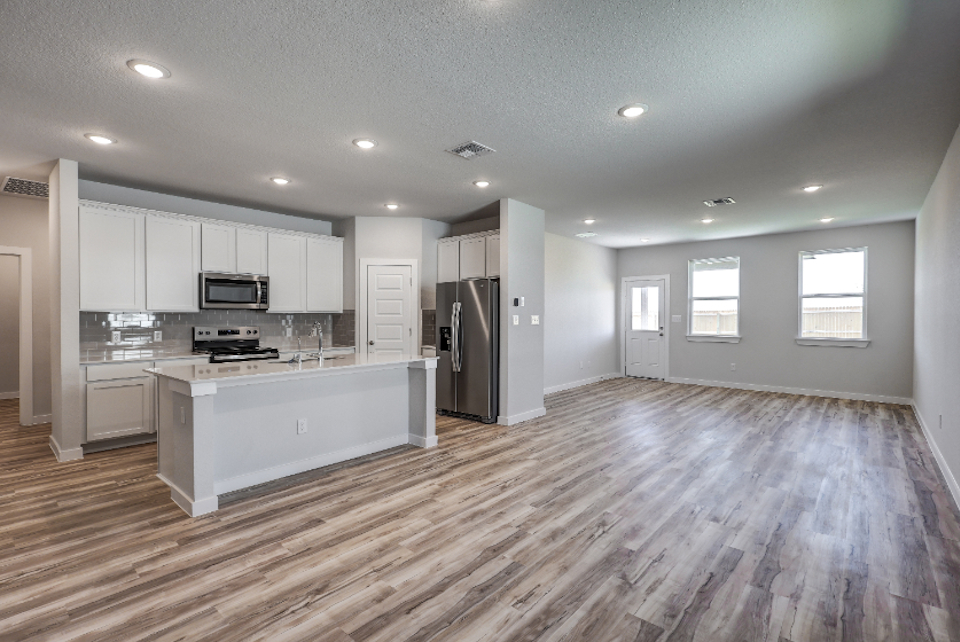 A large kitchen with white cabinets.