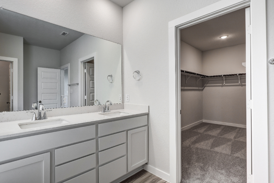 A bathroom with a large mirror.