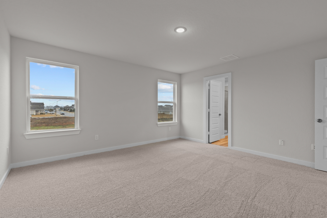 A room with a window and a carpet.