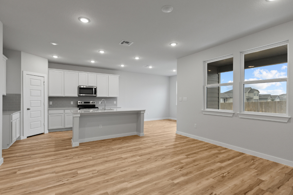 A kitchen with white cabinets.