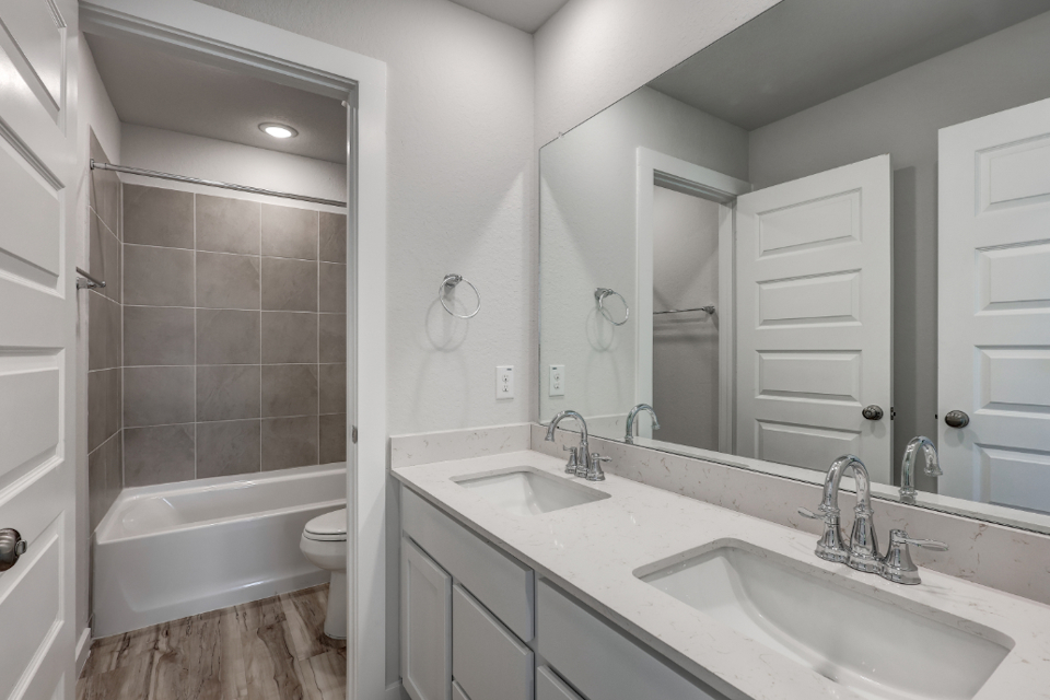 A bathroom with a tub sink and toilet.