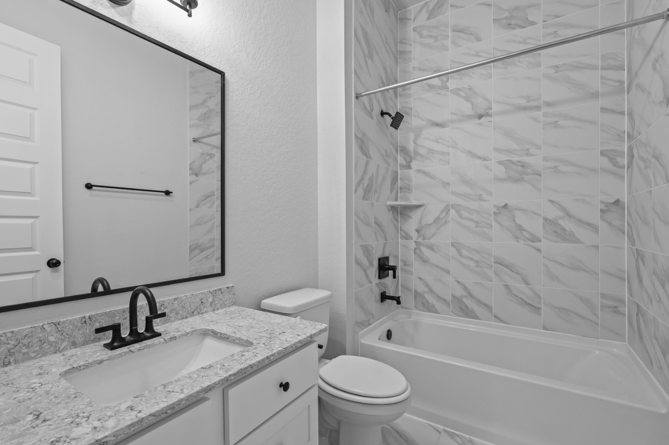 A bathroom with a shower and sink.