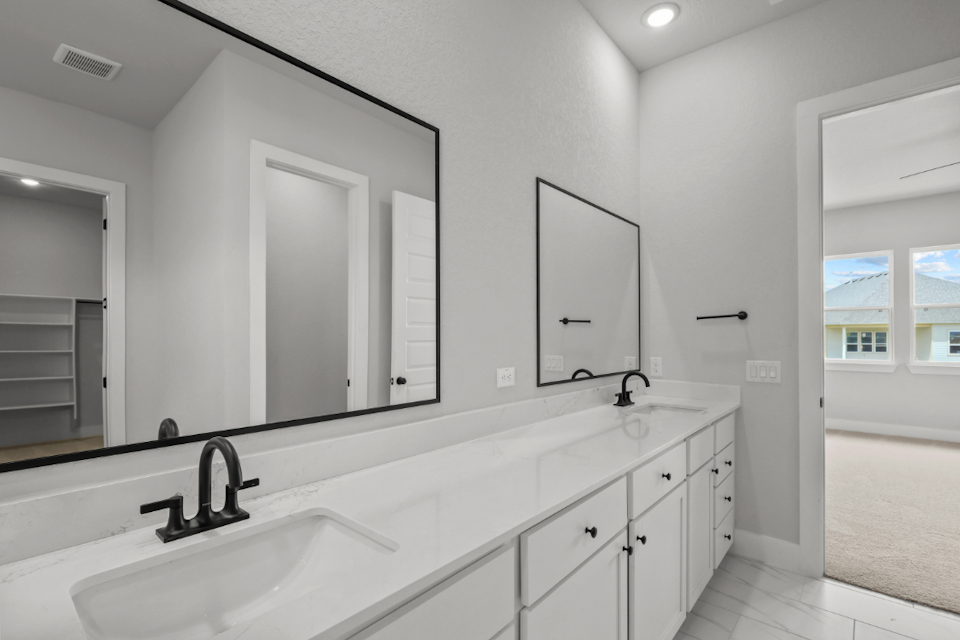 A bathroom with a large mirror.