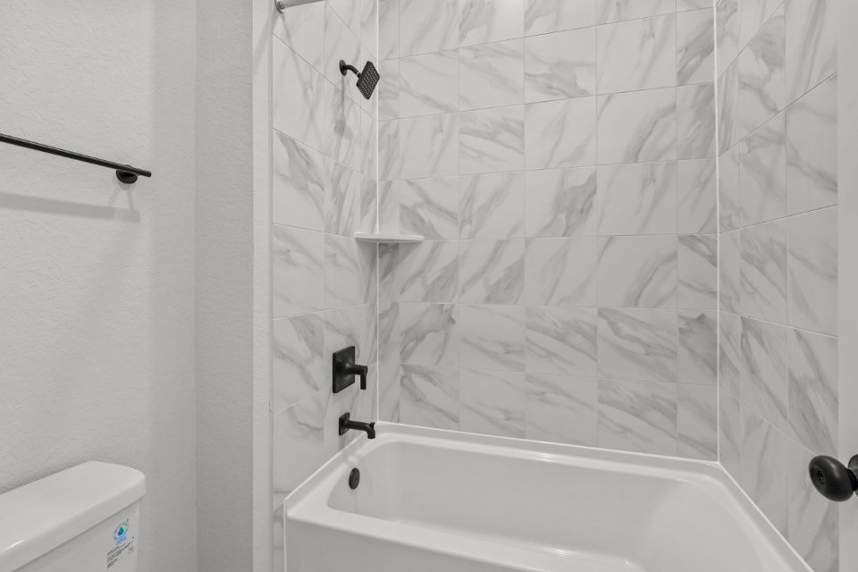 A bathtub with a shower curtain.