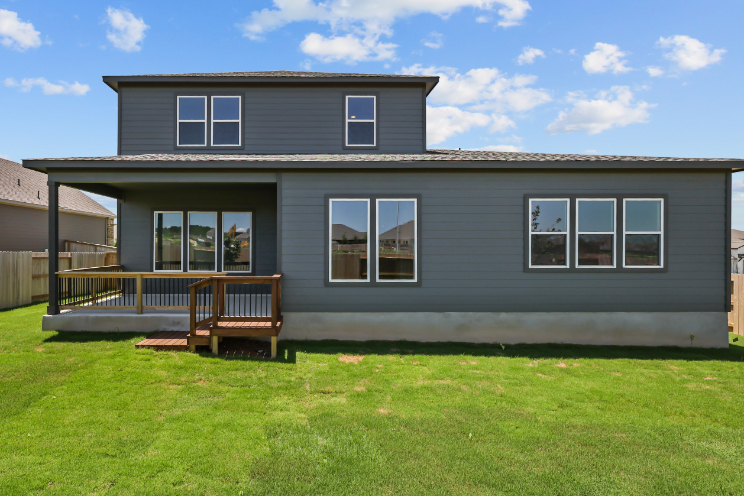 A house with a lawn and chairs.