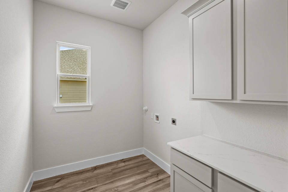 A room with white cabinets.