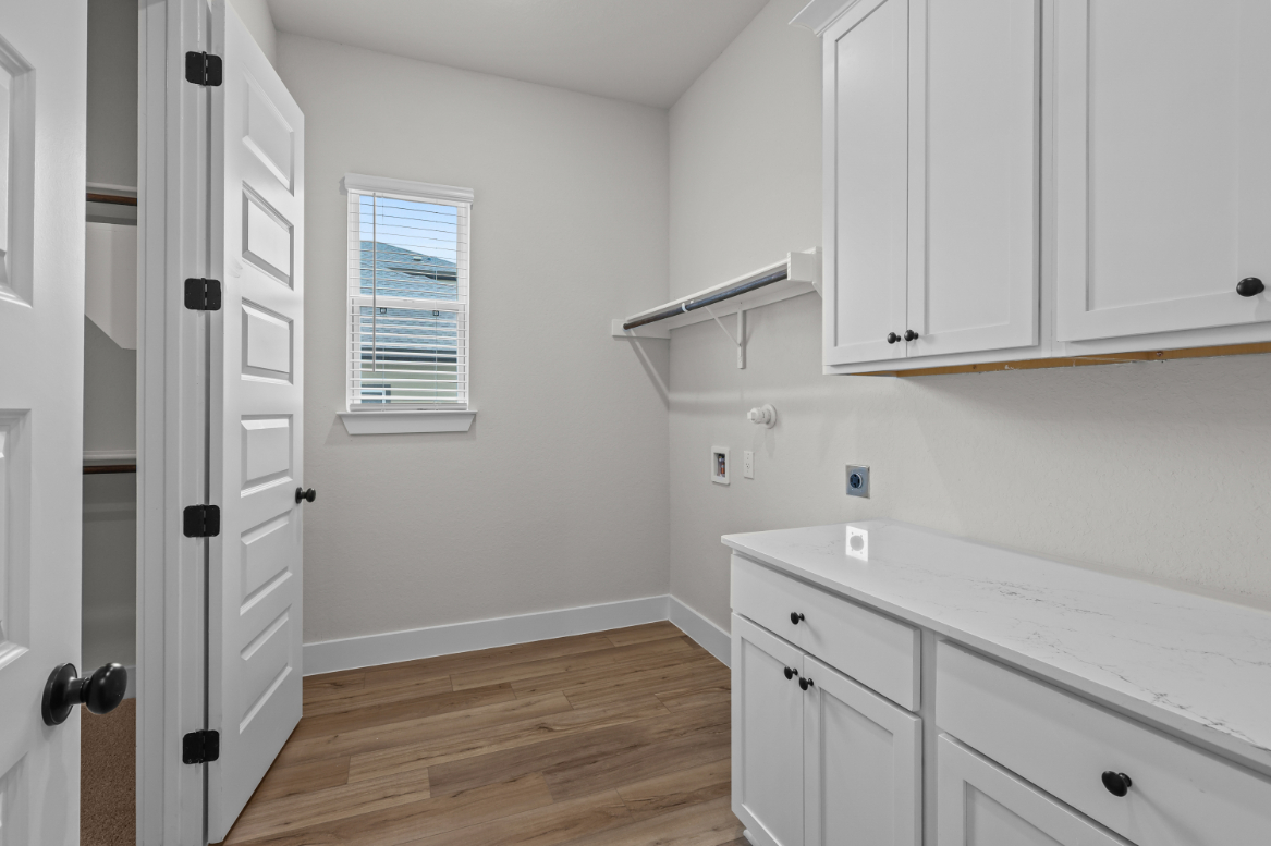 A room with white cabinets.
