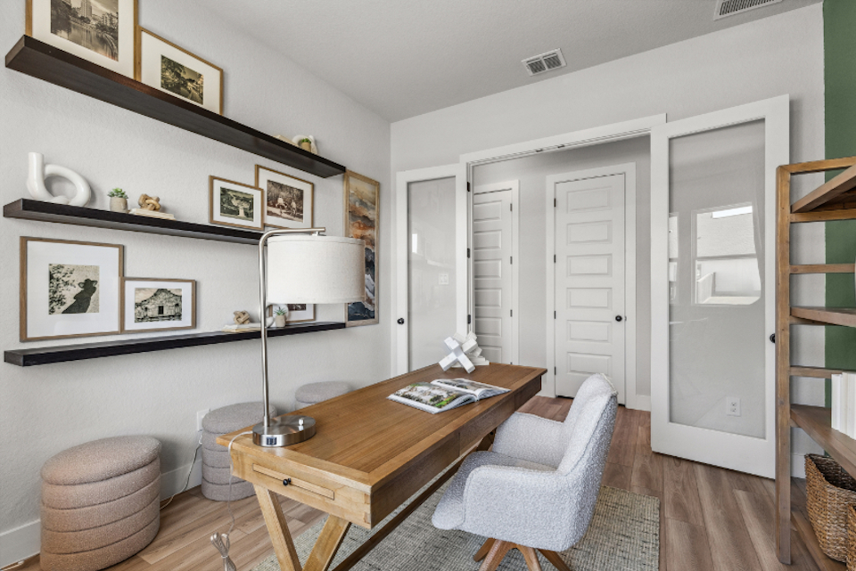 A living room with a table and chairs.