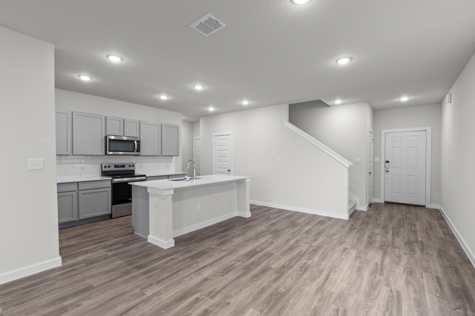 A kitchen with white cabinets.