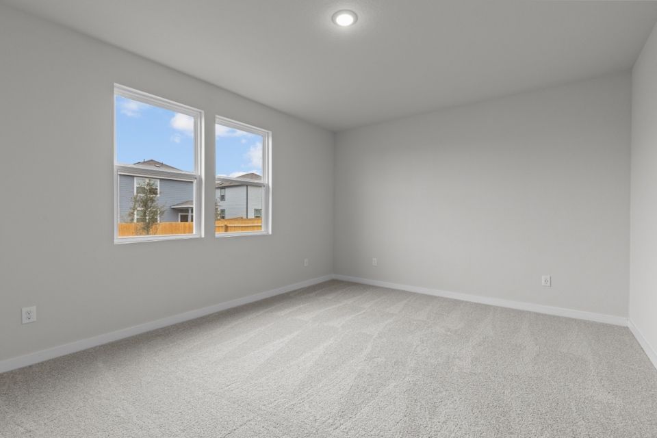 A room with a window and a white wall with a white floor.