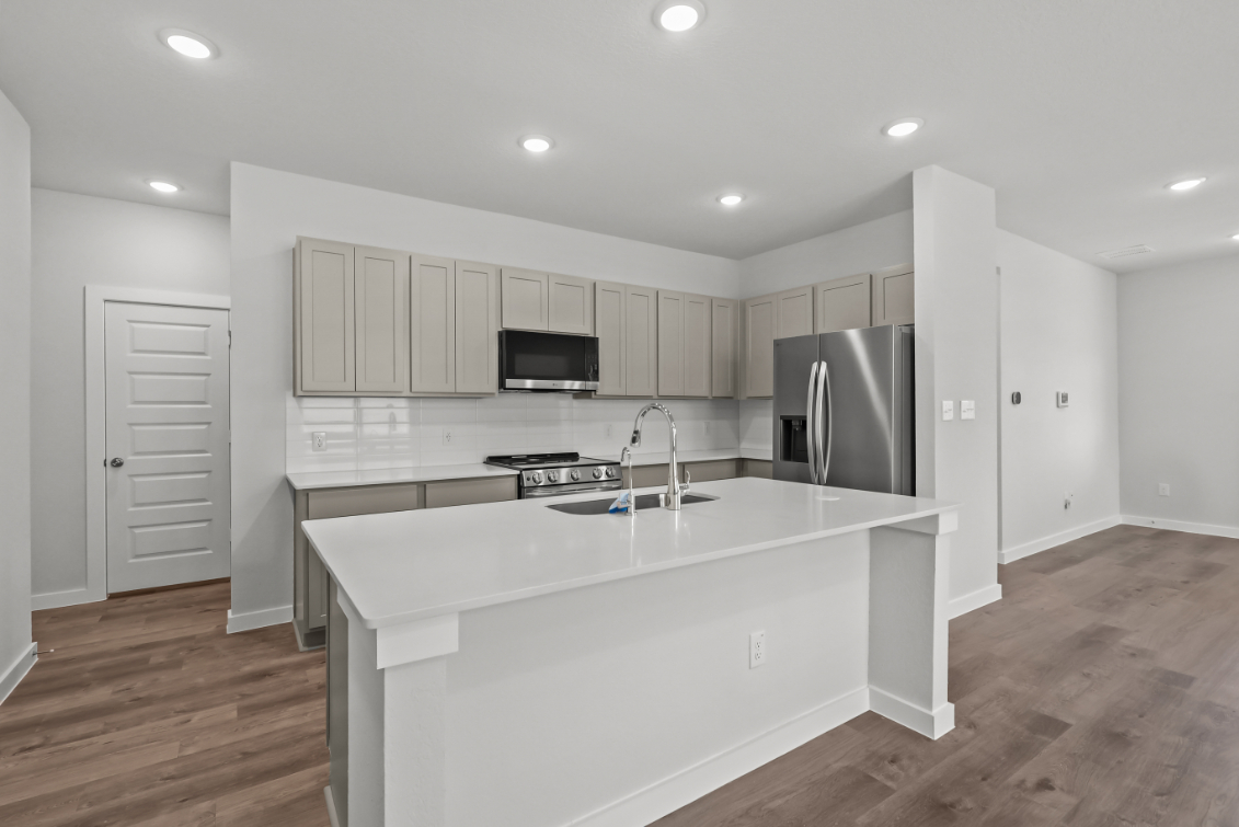A kitchen with white cabinets.