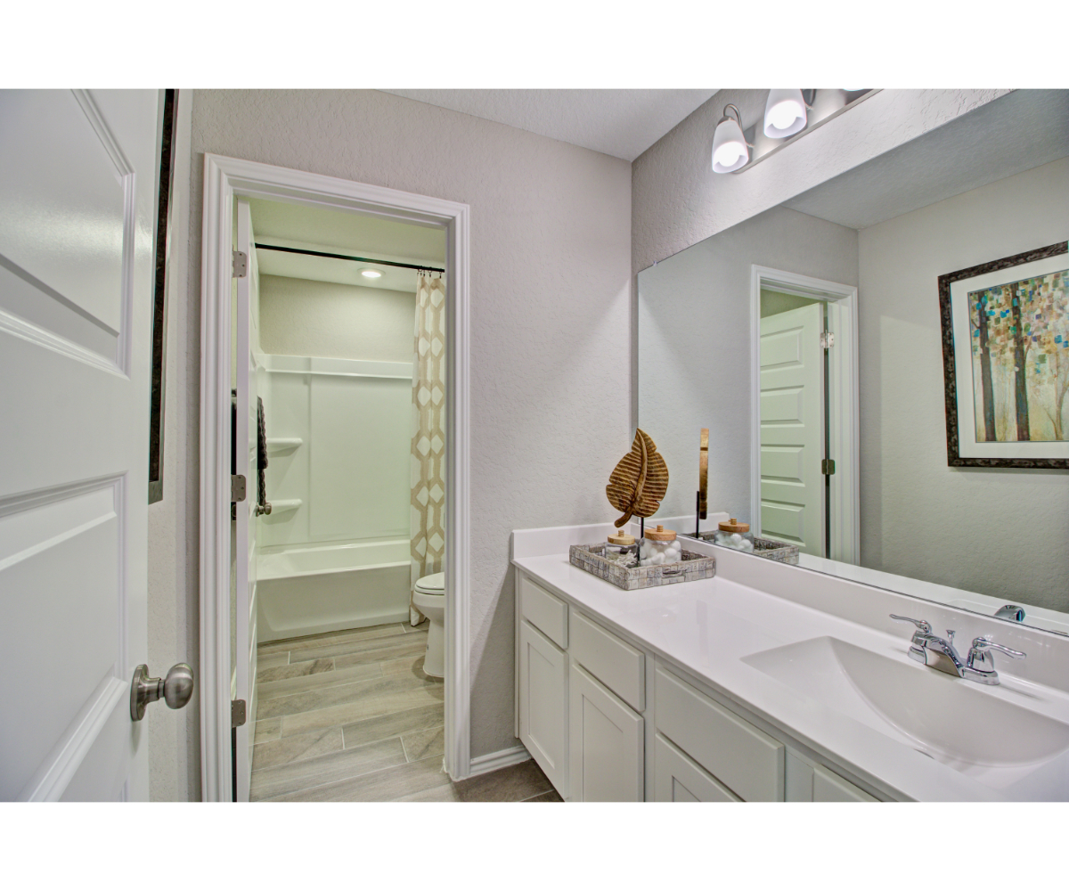 A bathroom with a tub sink and a shower.