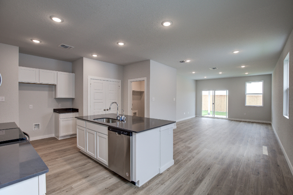 A kitchen with white cabinets.