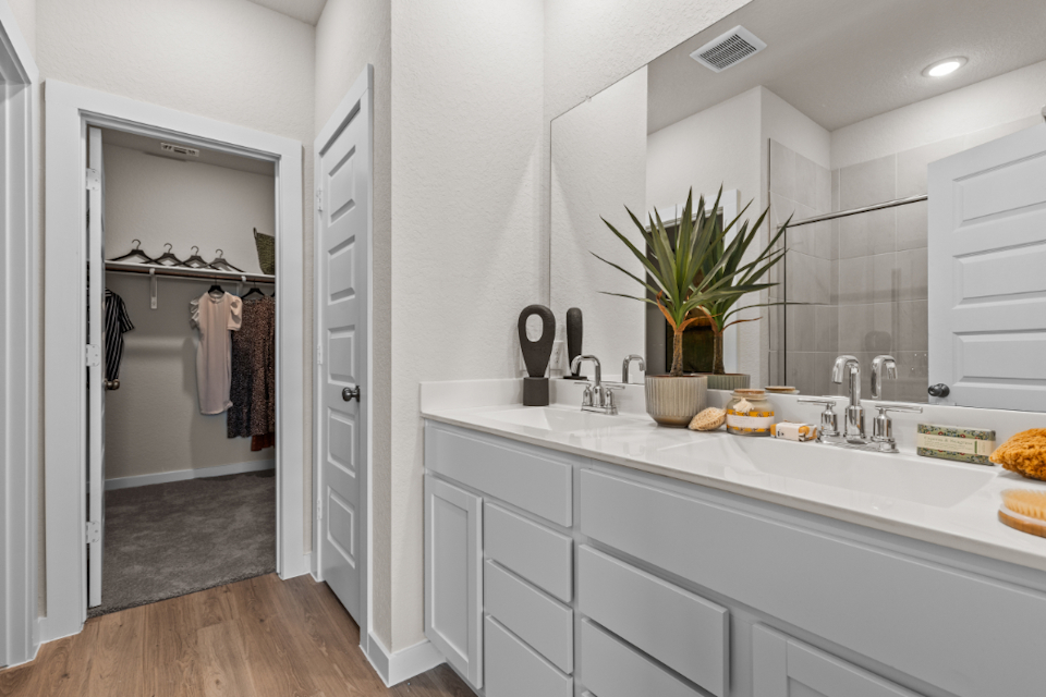 A bathroom with a sink and a shower unit.