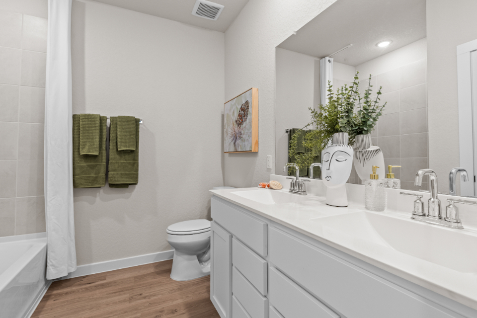 A bathroom with a tub sink and toilet.