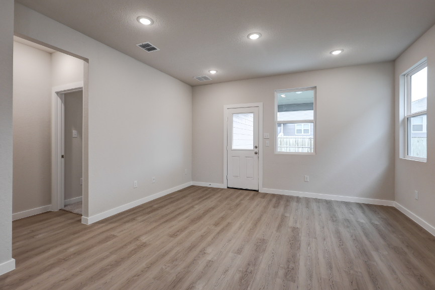 A room with a wood floor and white doors.