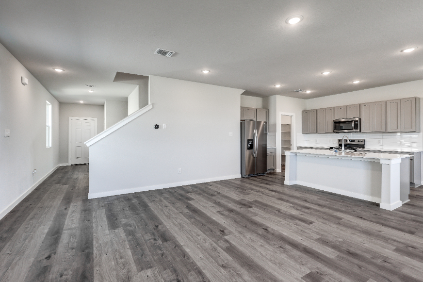 A kitchen with wooden floors.
