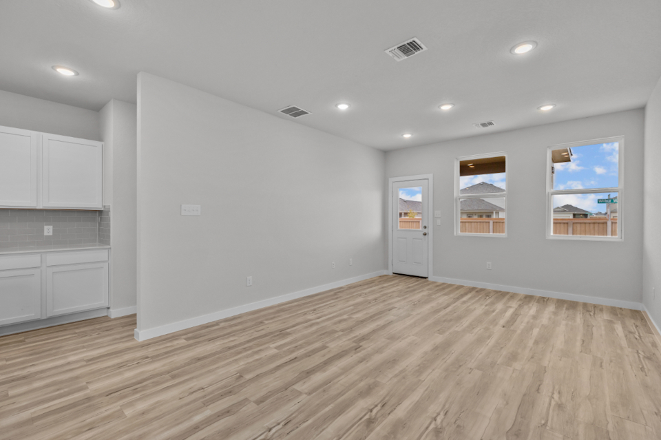 A room with white walls and a wood floor.