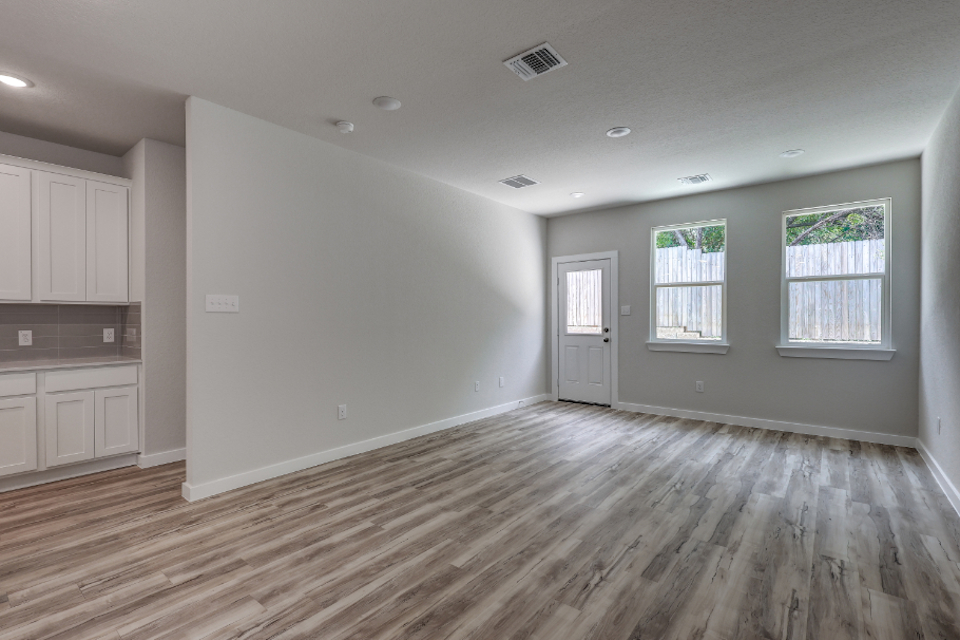 A room with a wood floor and white walls.