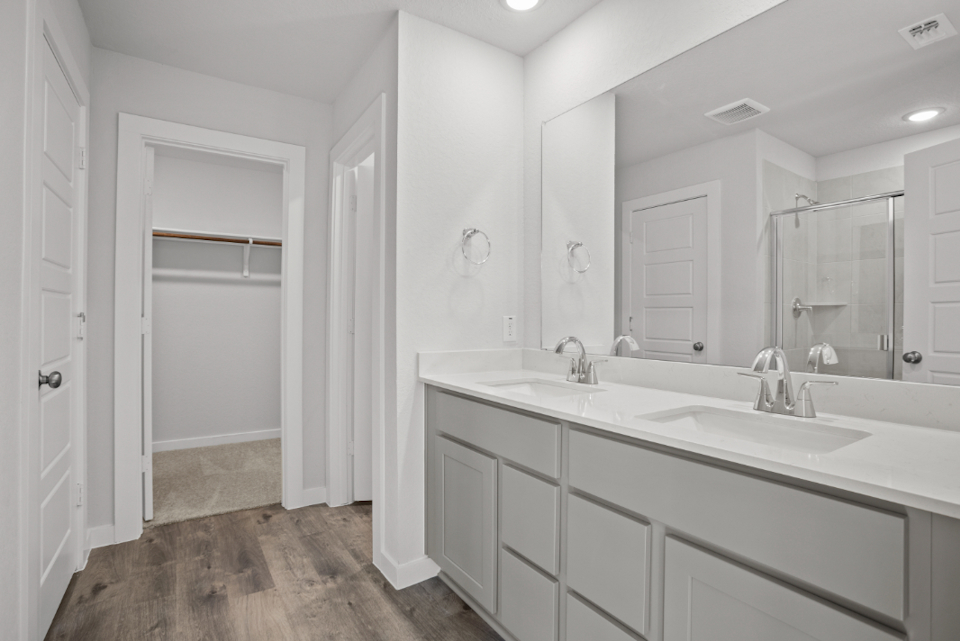 A bathroom with white cabinets.