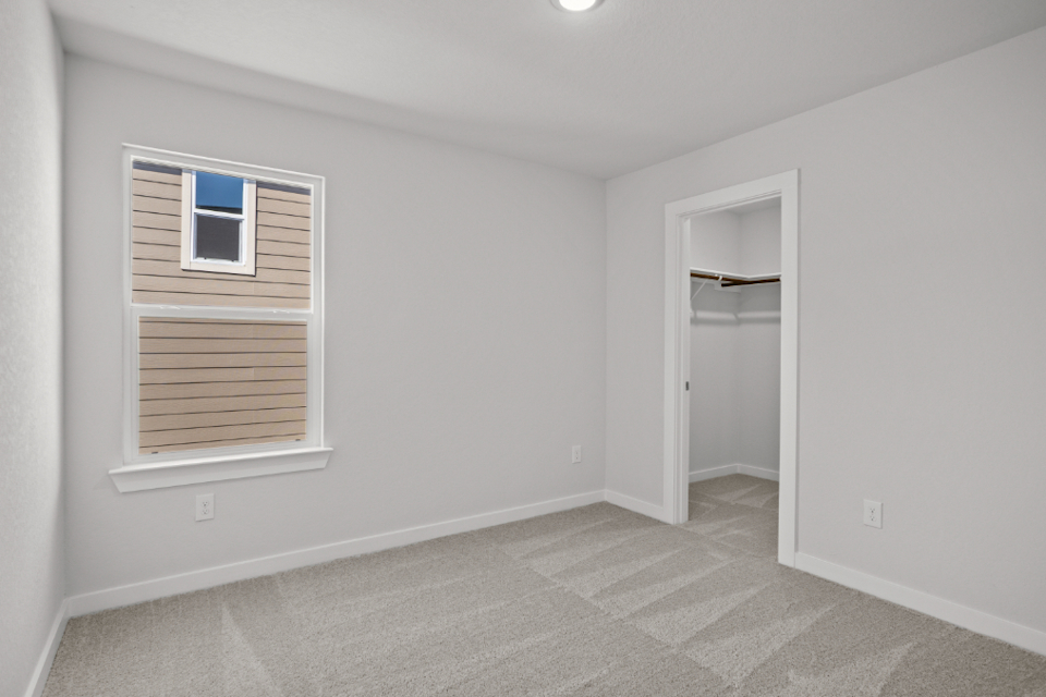 A room with a window and a door.