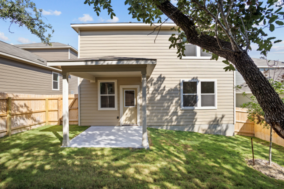 A house with a yard and a fence.