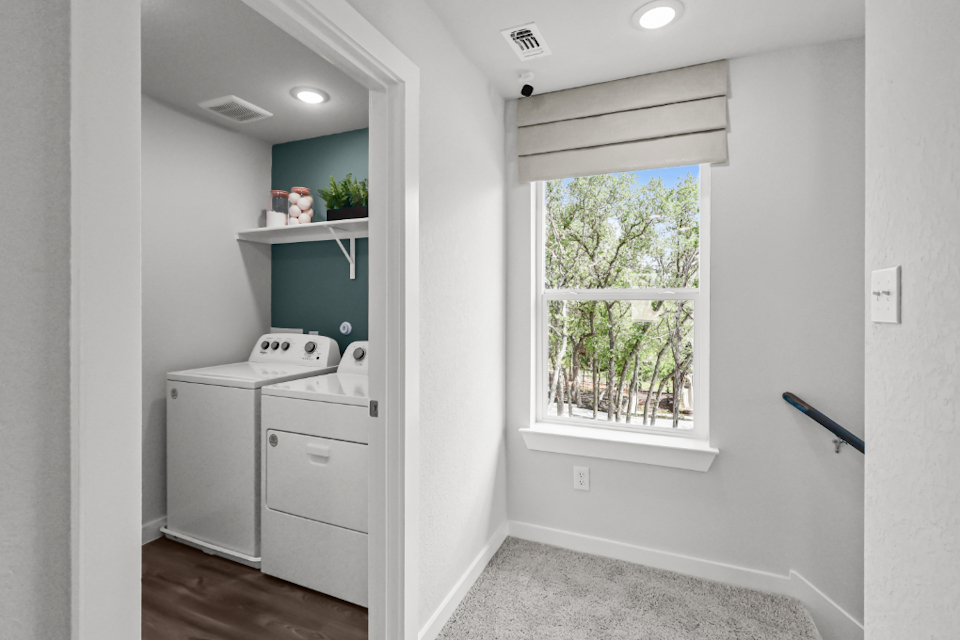 A white kitchen with a window.